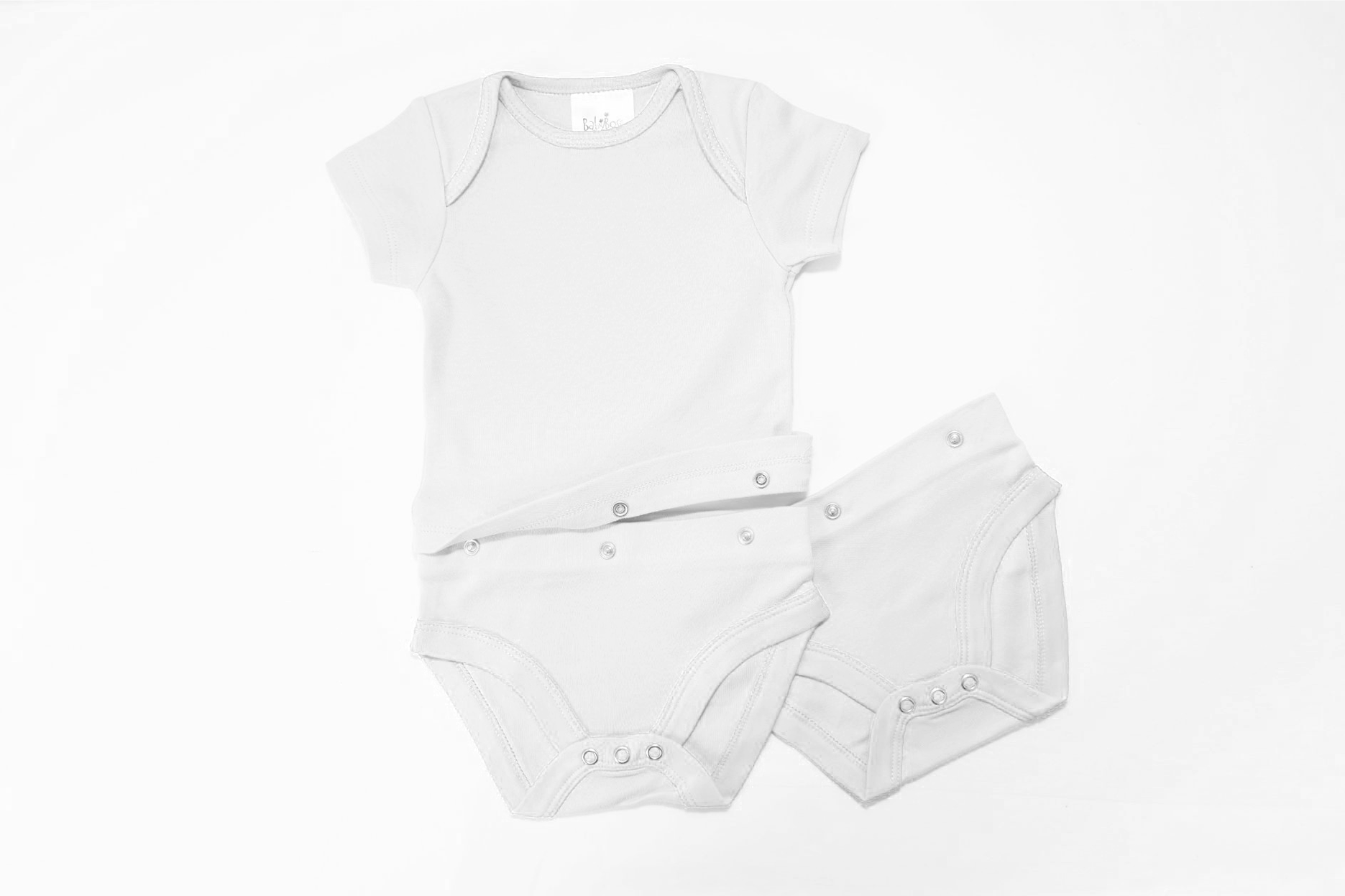 White two part baby vest with an additional set of bottoms in white. Middle section is folded up.